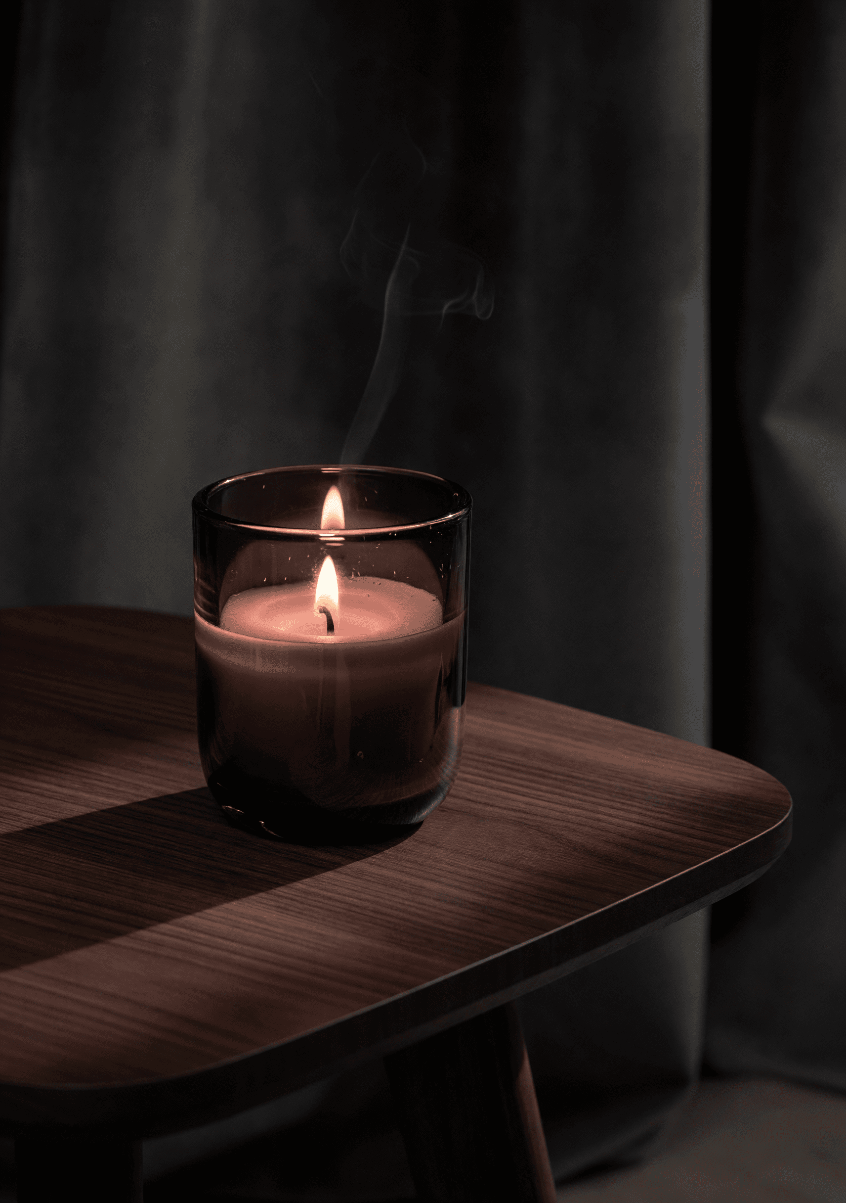 Marais — a lit candle in mouth-blown smoked-plum glass.